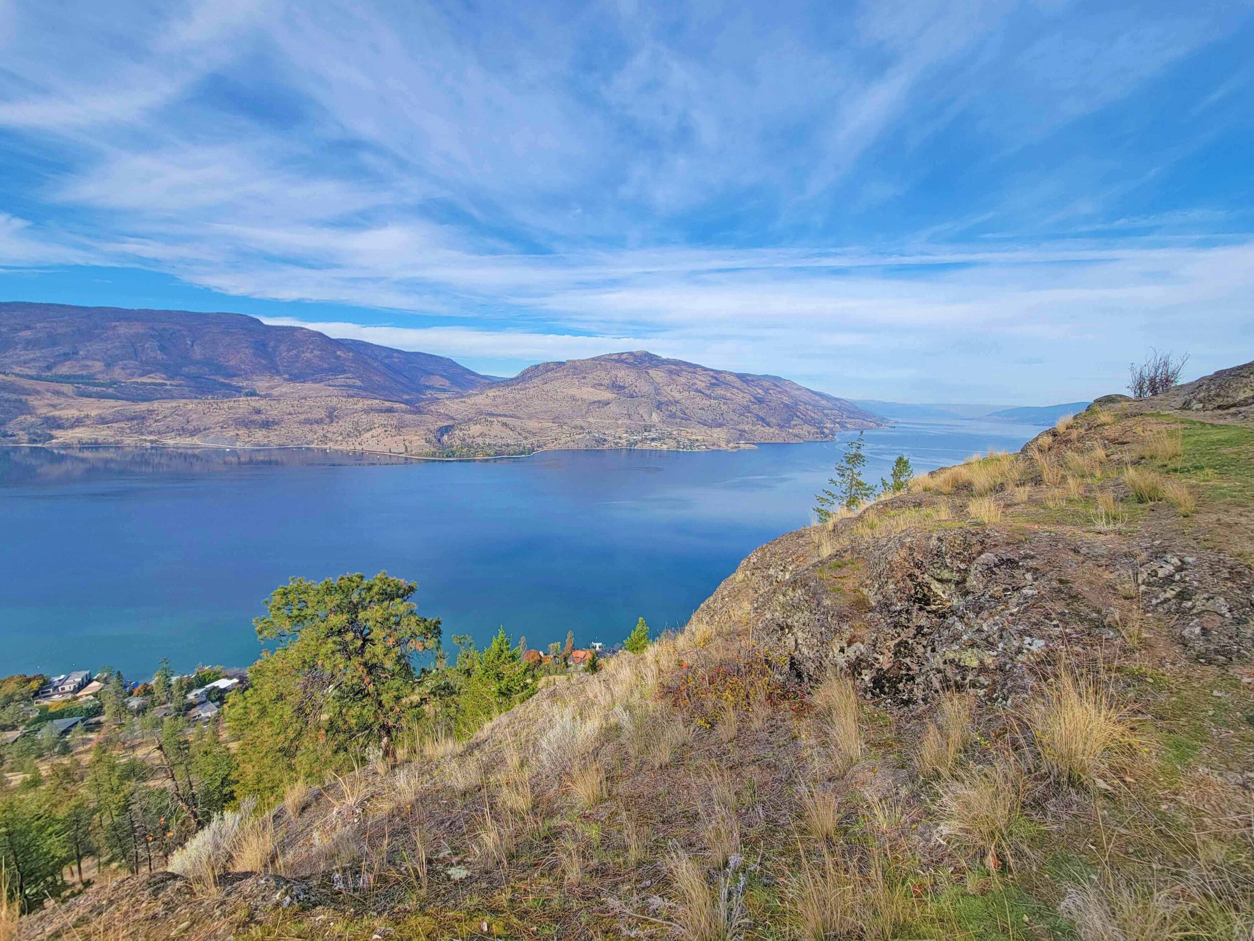 Panoramic view of Okanagan Lake and surrounding mountains from the rocky slopes of Knox Mountain