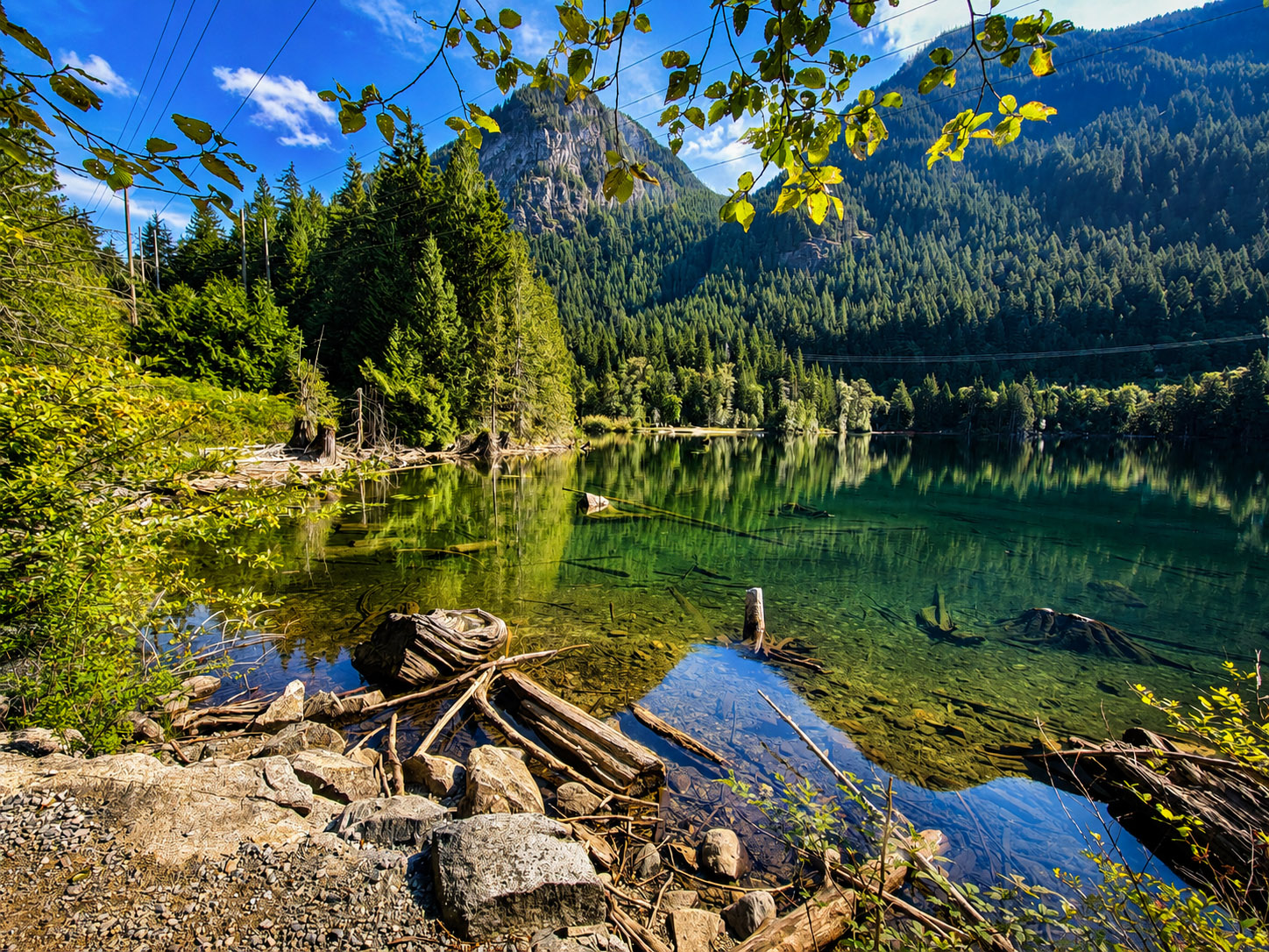 Clear water and a forested shoreline at Buntzen Lake